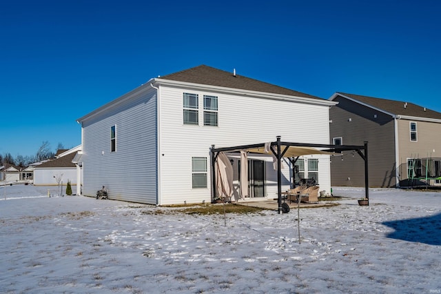 view of snow covered rear of property