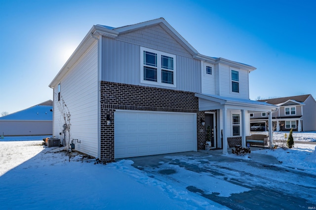 view of front of house with central AC and a garage