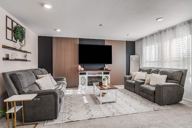 carpeted living room featuring a textured ceiling