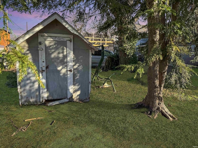 outdoor structure at dusk with a lawn