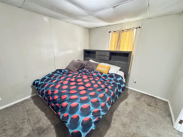 bedroom with carpet flooring and a paneled ceiling