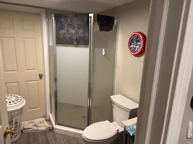 bathroom featuring toilet, vanity, walk in shower, and hardwood / wood-style floors