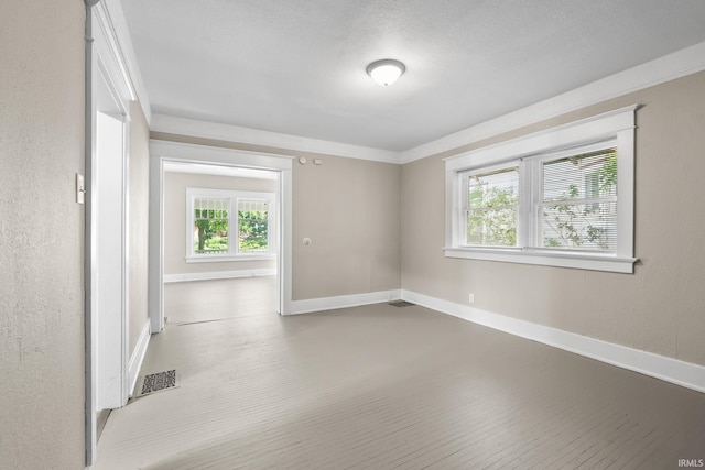 unfurnished room featuring hardwood / wood-style floors and ornamental molding