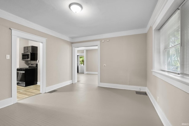 spare room featuring ornamental molding and plenty of natural light