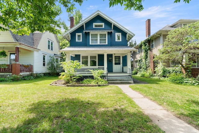 view of front of property with covered porch and a front lawn