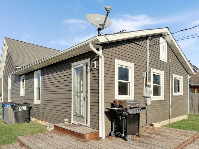 rear view of property featuring a wooden deck