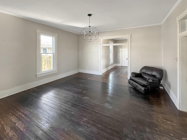 unfurnished dining area featuring dark hardwood / wood-style flooring, ornamental molding, and a chandelier