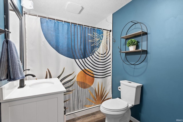 bathroom with toilet, a textured ceiling, hardwood / wood-style floors, a shower with curtain, and vanity