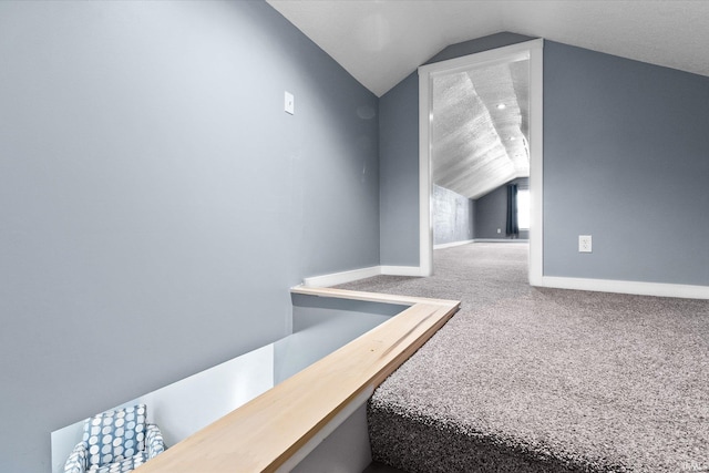 interior space with lofted ceiling and carpet floors