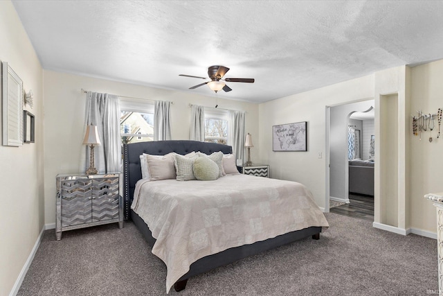 carpeted bedroom with a textured ceiling and ceiling fan