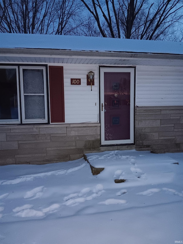 view of snow covered property entrance