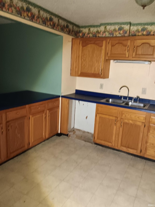 kitchen featuring sink and a textured ceiling