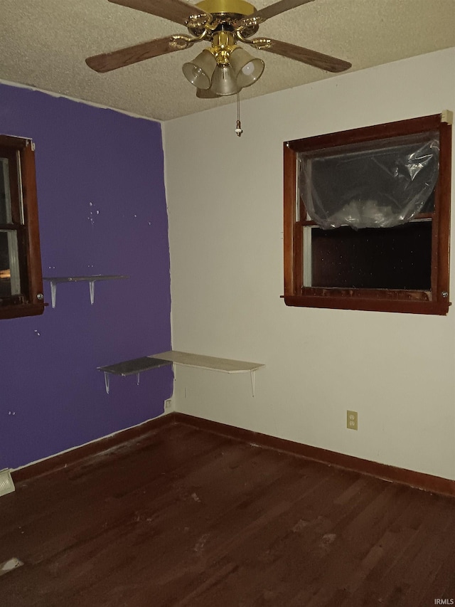 empty room with a textured ceiling, ceiling fan, and hardwood / wood-style floors