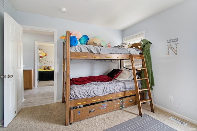 bedroom featuring light carpet