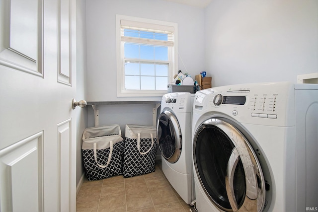 laundry room featuring light tile patterned floors and washer and clothes dryer