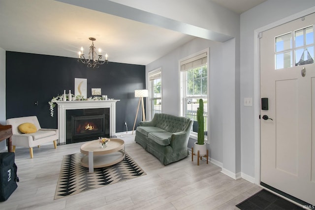 entrance foyer featuring an inviting chandelier and light hardwood / wood-style flooring