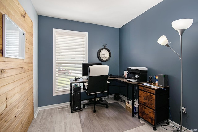 office featuring wood walls and light hardwood / wood-style flooring