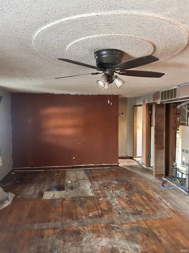 unfurnished room featuring a textured ceiling, ceiling fan, and dark hardwood / wood-style floors