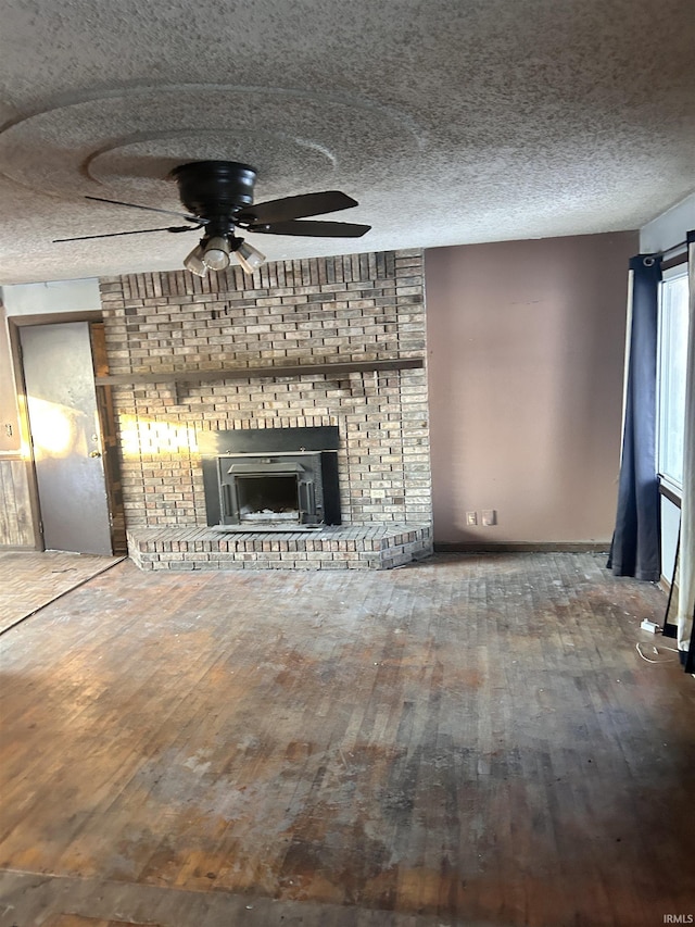 unfurnished living room featuring ceiling fan and hardwood / wood-style flooring