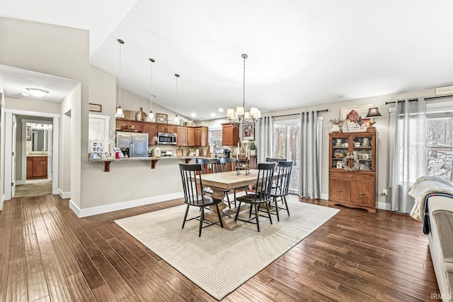 dining area featuring high vaulted ceiling, an inviting chandelier, and dark hardwood / wood-style flooring