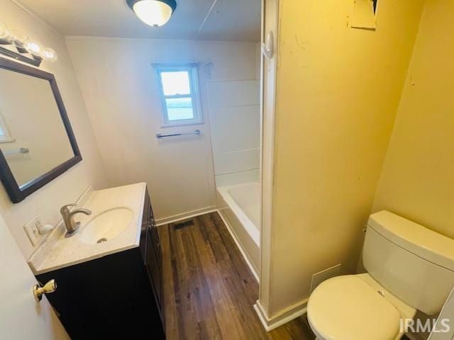 full bathroom with toilet, shower with separate bathtub, wood-type flooring, and vanity