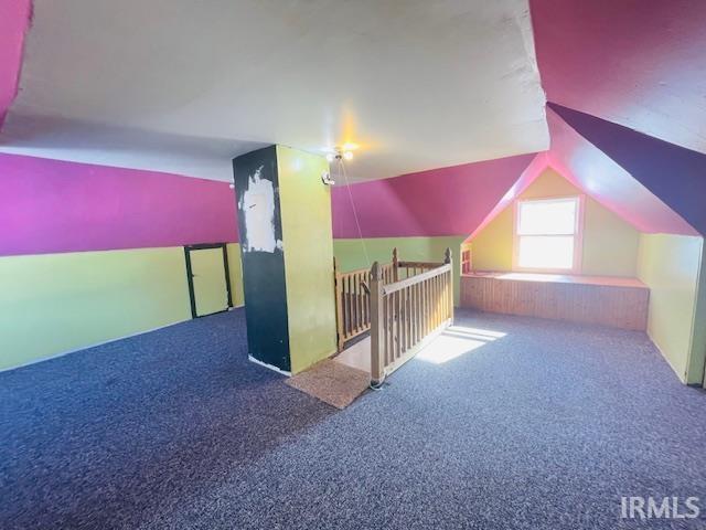 bonus room featuring carpet floors and vaulted ceiling