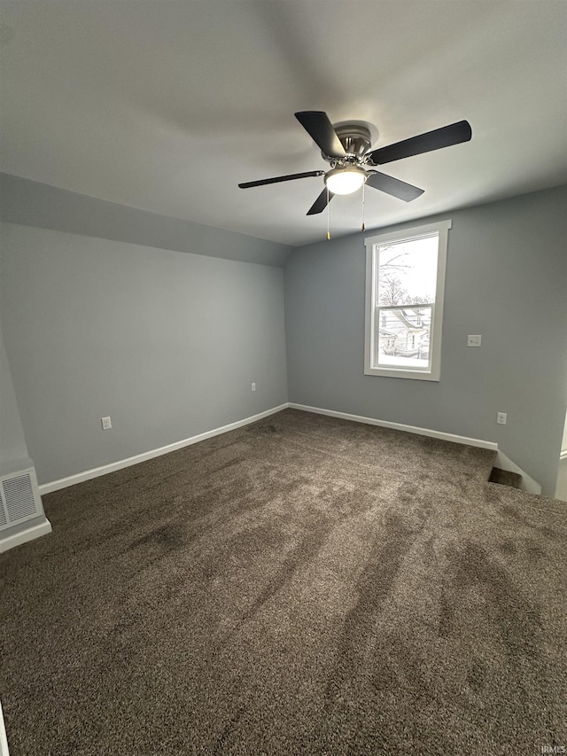 empty room with ceiling fan and carpet flooring