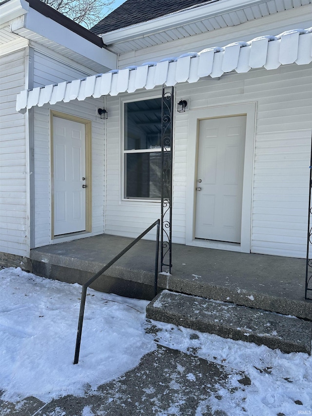 view of snow covered property entrance