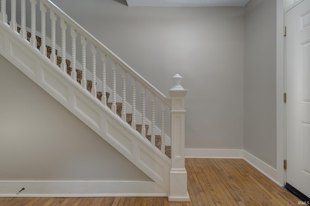 staircase with wood-type flooring