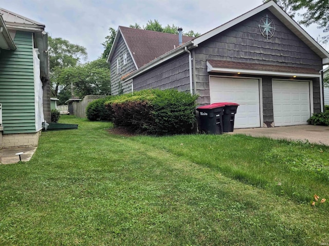 view of side of home featuring a yard and a garage