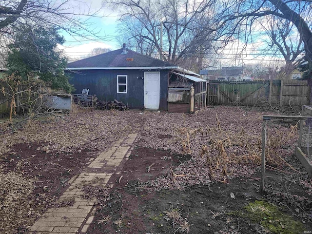 back of property featuring an outbuilding