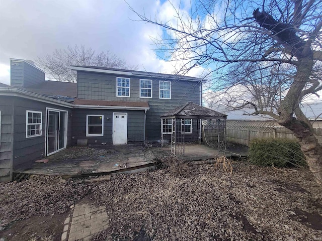 rear view of house with a gazebo and a patio area