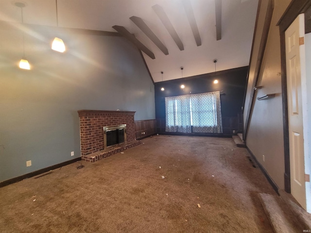 unfurnished living room with a brick fireplace, high vaulted ceiling, beam ceiling, and dark carpet