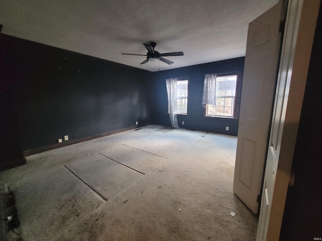 spare room with a textured ceiling and ceiling fan