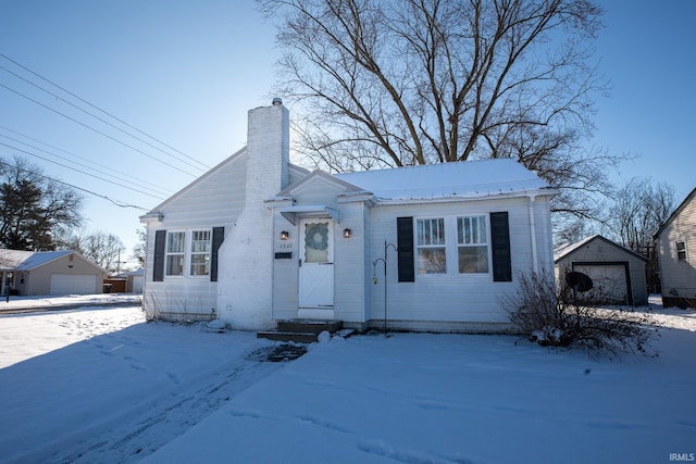 view of front facade featuring a garage and an outdoor structure