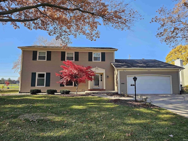 view of front of house featuring a front lawn and a garage