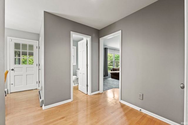 interior space featuring a baseboard radiator and light hardwood / wood-style flooring