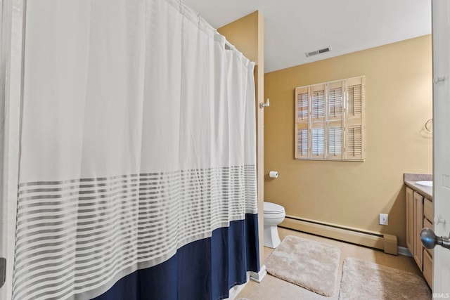 bathroom with toilet, a baseboard heating unit, and vanity