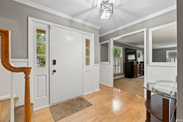 entrance foyer featuring light wood-type flooring, a baseboard radiator, and crown molding