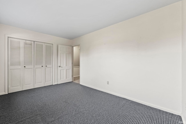 unfurnished bedroom with dark carpet