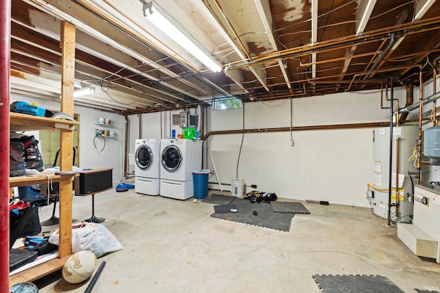 basement with water heater and independent washer and dryer