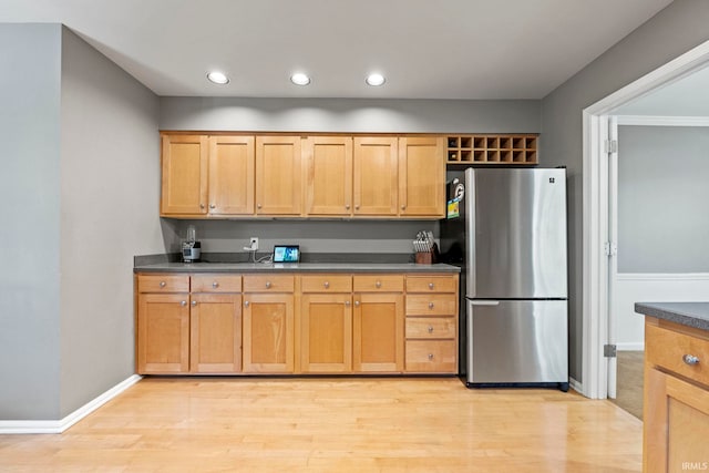 kitchen with stainless steel fridge and light wood-type flooring