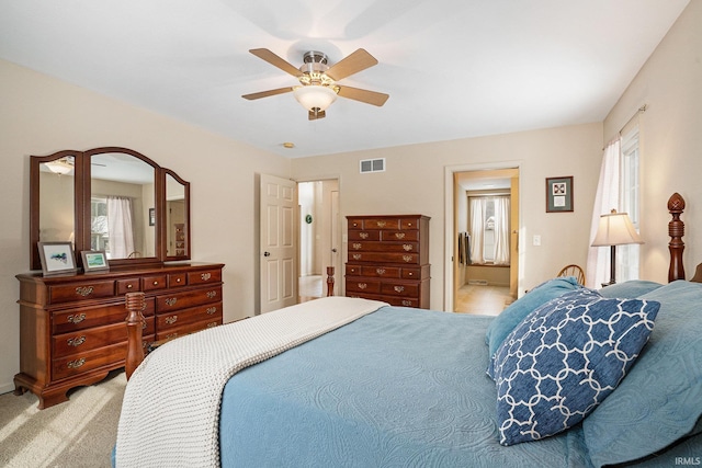 carpeted bedroom featuring ceiling fan and multiple windows