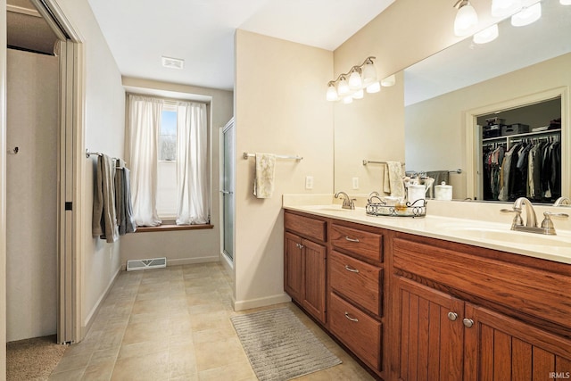 bathroom featuring an enclosed shower and vanity