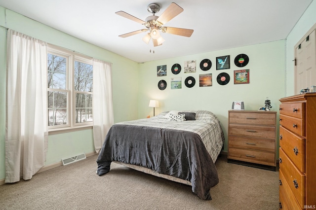 bedroom with ceiling fan and light colored carpet