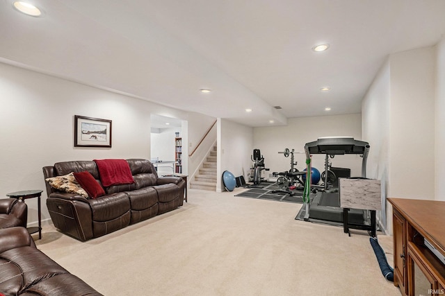 exercise room featuring light carpet