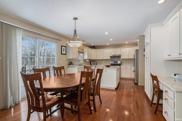 dining room featuring sink and wood-type flooring