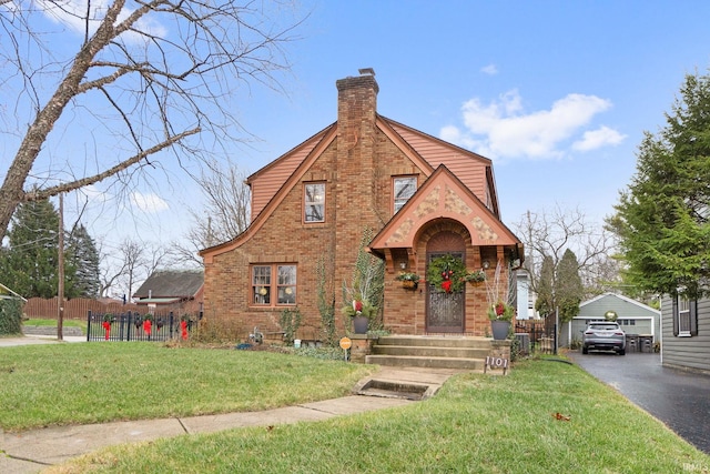 english style home with a garage and a front yard