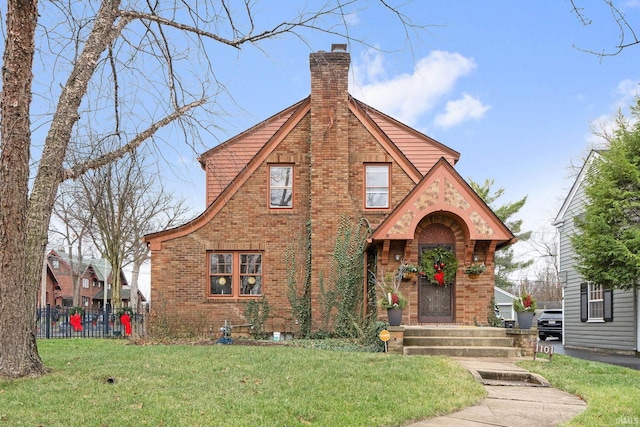 tudor-style house with a front yard