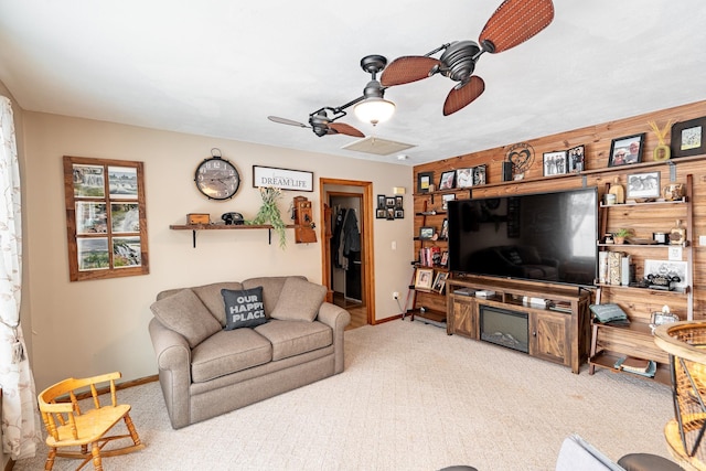 carpeted living room featuring ceiling fan